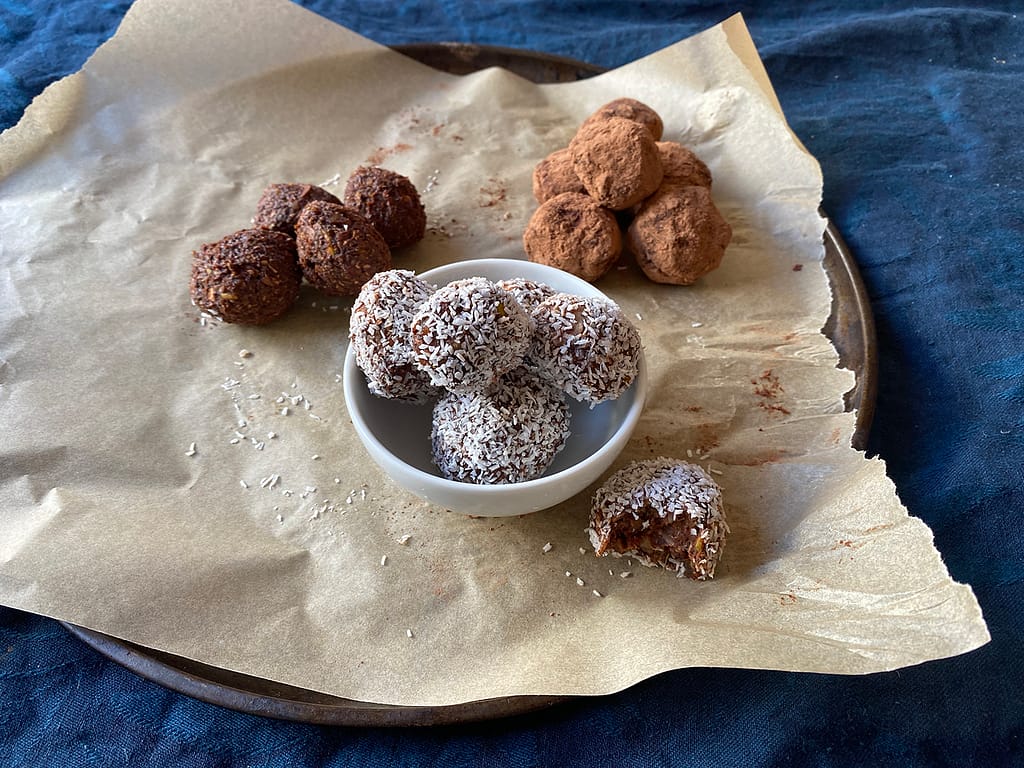 cacao bliss balls - yummy! cacao balls recipe completed with bowl of balls with coconut, rolled in cacao and plain