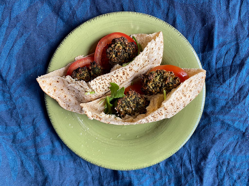 healthy baked falafel recipe - vegan baked falafel in pita bread with salad on plate