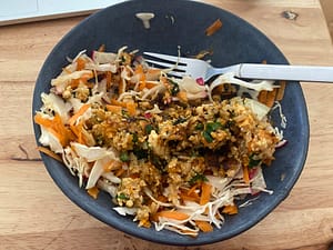 carrot and cabbage slaw with tofu and rice mess on top