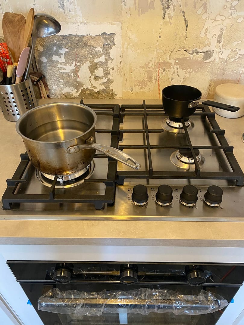 the hob with two saucepans and cooking away